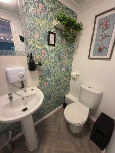 a bathroom with a toilet and a sink at Thorpe Park Studio - Detached Stay & Free Gated Parking in Thorpe