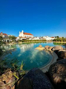 a large body of water with rocks in it at Casa do Castelo in Belver