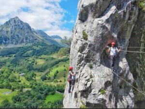 two people are climbing on a mountain at Casa bella alma in Ramales de la Victoria