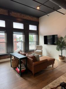 a living room with a couch and a table at The Cozy Corner - Downtown Troy in Troy