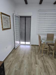 a dining room with a table and a laptop on it at Apartamentos vacacionales malba in Punta Umbría +6 photos