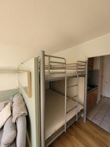 a bunk bed room with two bunk beds and a kitchen at appartement superdevoluy in Le Dévoluy