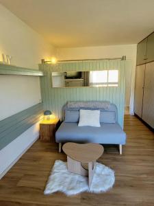 a small bedroom with a bed and a table at appartement superdevoluy in Le Dévoluy