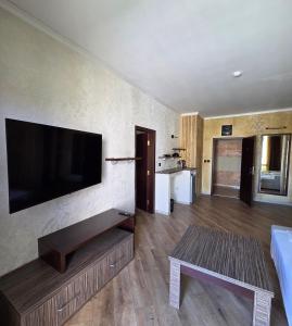 a living room with a flat screen tv on the wall at Art Hotel Babylon in Sunny Beach +79 photos