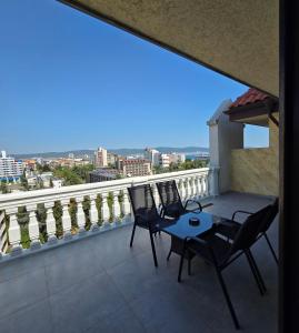 a balcony with chairs and a table and a view at Art Hotel Babylon in Sunny Beach