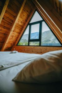 a bed in a room with a large window at Ski Vista house in Žabljak