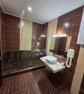 a bathroom with a sink and a bath tub at Art Hotel Babylon in Sunny Beach