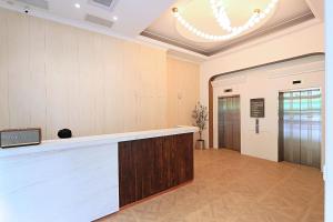 an office lobby with a reception counter and a door at Herkang Hotel in Taichung