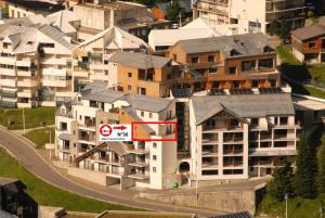 an apartment building with a no left turn sign in a city at Résidence Le Portillo - Piscine - 2 Pièces pour 8 Personnes MAE-6123 in Gourette