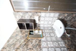a bathroom with a toilet and a sink at Nova Resorts in Rāe Bareli