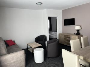 a living room with a couch and a table with chairs at Résidence Le Portillo - Piscine - 2 Pièces pour 8 Personnes MAE-6123 in Gourette