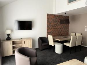 a dining room with a table and chairs at Résidence Le Portillo - Piscine - 2 Pièces pour 8 Personnes MAE-6133 in Gourette +4 photos