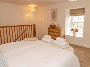 a bedroom with a large bed with towels on it at Pentwyn in Solva