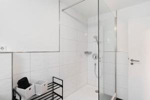 a bathroom with a shower with a glass door at Ferienhaus Marina in Baden-Baden +27 photos