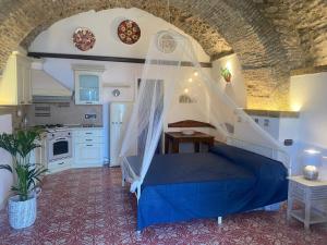 a bedroom with a bed and a staircase in a room at Agave Residence House 12 in Pomarico +14 photos