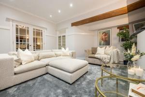 a living room with a couch and a table at The Coach House - Grade 2 Listed in Hale