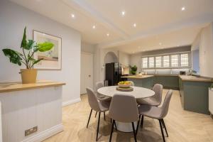a kitchen and dining room with a table and chairs at The GreyStoke Mansion With Private Grounds in Hale
