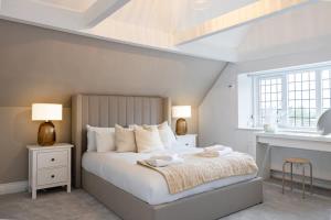 a white bedroom with a large bed and a window at The GreyStoke Mansion With Private Grounds in Hale