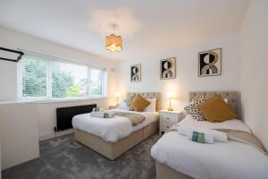 a bedroom with two beds and a window at The Wilmslow House Free Parking - Close to Airport in Alderley Edge
