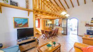 Il comprend un salon avec une télévision à écran plat et une cuisine. dans l'établissement Casa La Haza de Frigiliana by Ruralidays, à Frigiliana