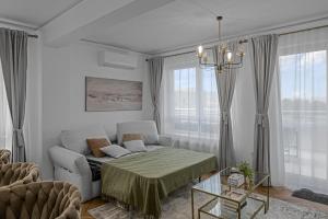 a living room with a couch and a chair at FLH - Panoramic Garden Luxury Apt in Cristian