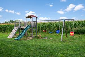 a playground with a slide in the grass at FLH - Panoramic Garden Luxury Apt in Cristian