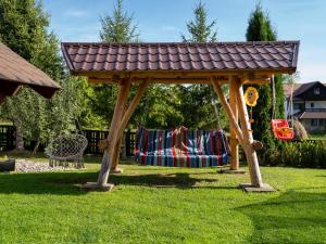 a wooden gazebo with a blanket in a yard at Casa Nicoleta in Bran