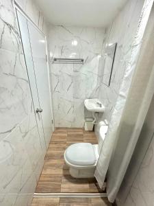a bathroom with a toilet and a sink at Bike Works Inn Bang Tao in Ban Thalat Choeng Thale +25 photos