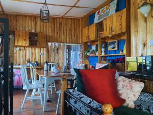 a living room with a couch and a table at Lemon Valley Farm in Elmenteita