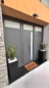 a garage with two potted plants on a building at Il Vicoletto room in Mercato San Severino