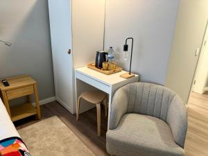 a bedroom with a desk and a chair and a mirror at Vera Cruz Guesthouse in Angra do Heroísmo