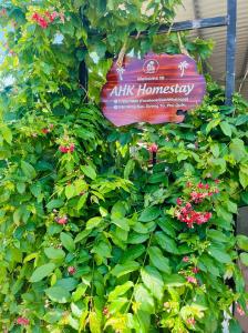 a bush with pink flowers and a sign on it at AHK Homestay 1 in Phu Quoc
