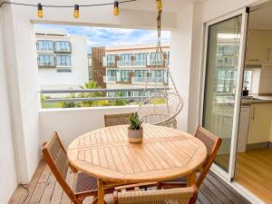 a wooden table and chairs on a balcony at Resort house with Pools and Private beach in Tavira