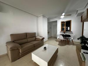 a living room with a couch and a table at Vacaciones en primera línea in El Borseral