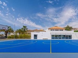 a basketball court in front of a building at Resort house with Pools and Private beach in Tavira