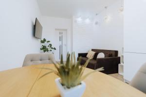 a dining room with a table with a plant on it at Modern Stay Rîșcani, AC, WiFi, Washer in Chişinău