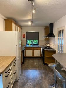 a kitchen with a white refrigerator and a window at 3BR House Self Check In Parking By PlushPad in Shenley Lodge