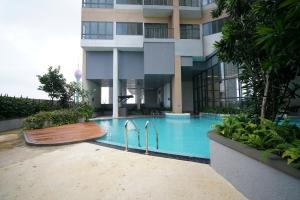 a swimming pool in front of a building at Skyline Heights Colombo in Colombo