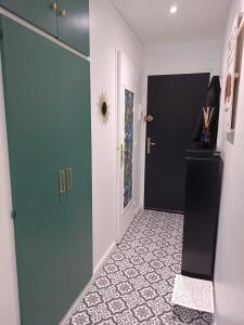 a hallway with a blue door and a tile floor at Le studio Amos in Metz