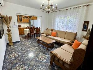 a living room with a couch and chairs and a table at Villa Agos in Shkodër