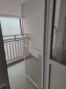 a glass door in a room with a balcony at Apartament Adriano in Turda