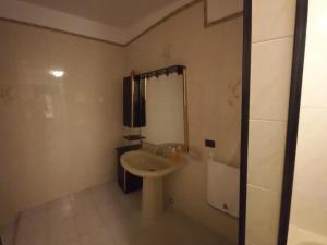 a white bathroom with a sink and a shower at Molentargius Domus in Quartu SantʼElena +23 photos
