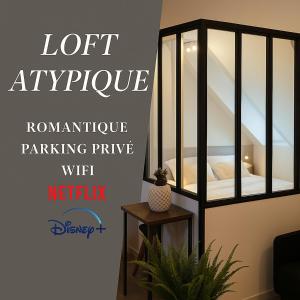 a room with a room with a bed in a glassoir at Appartement Atypique- Esprit Atelier Loft - parking privé - Wifi - vidéo in Amiens
