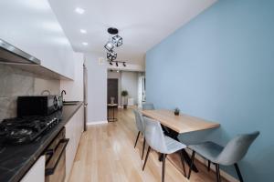 a kitchen and dining room with a table and chairs at Modern 1BR Great Area Near McDonalds Riscani in Chişinău
