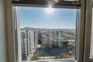 a view of a city from a window at Modern 1BR Great Area Near McDonalds Riscani in Chişinău