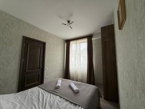 a bedroom with a bed with two towels on it at Bakuriani, Trialeti Residence in Bakuriani