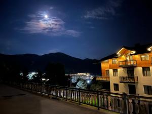 a view of a building at night with the moon at Bakuriani, Trialeti Residence in Bakuriani