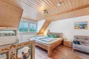 a bedroom with a bed and a couch at Ruhbauernhof in Kirchzarten