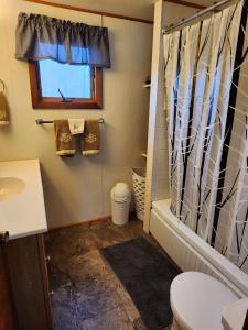 a bathroom with a tub and a toilet and a sink at Country Living in West Monroe