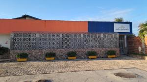 a building with a wall with squares on it at Suítes Flecheiras in Flecheiras